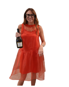 Kim Bode smiles with a bottle of champagne.