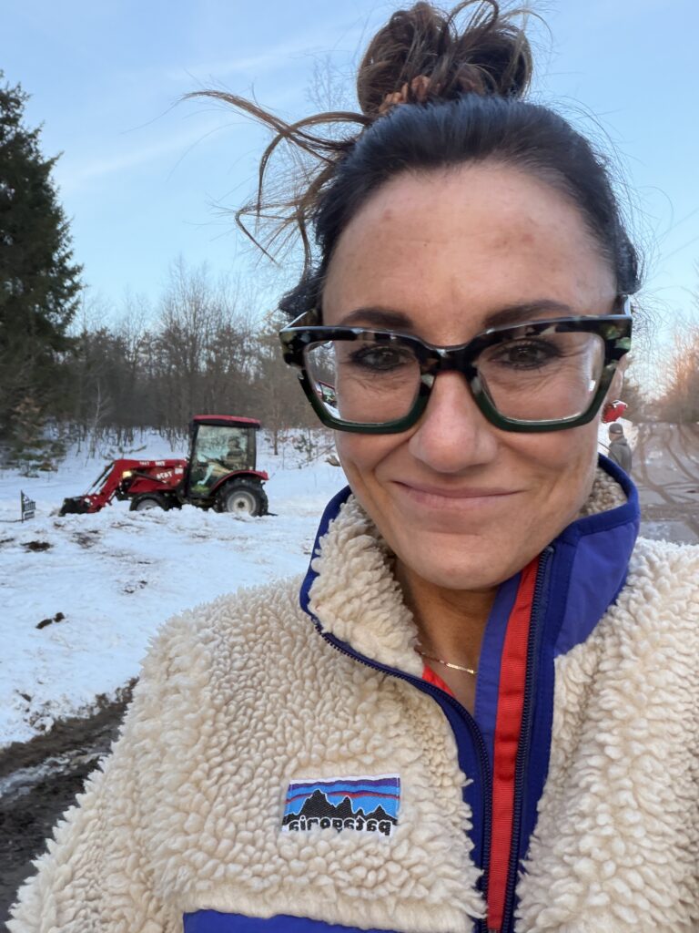 Kim Bode stands at the bottom of her cabin driveway as it is plowed out.