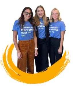 Kim smiles with 8THIRTYFOUR team members. Their shirts read, "As strong as the woman next to me."