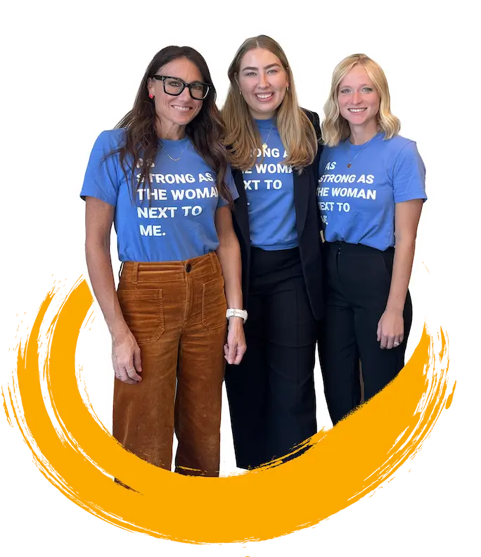 Kim smiles with 8THIRTYFOUR team members. Their shirts read, "As strong as the woman next to me."