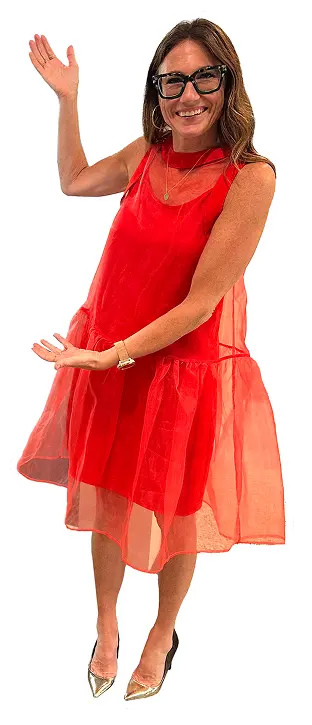 Kim Bode stands and gestures at something to the left with both hands.