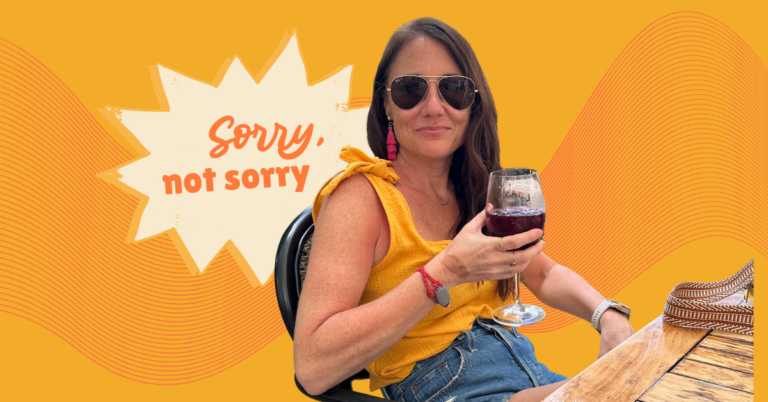 Kim Bode relaxes on a patio with a glass of iced wine in her hand. A speech bubble says, "Sorry, not sorry."